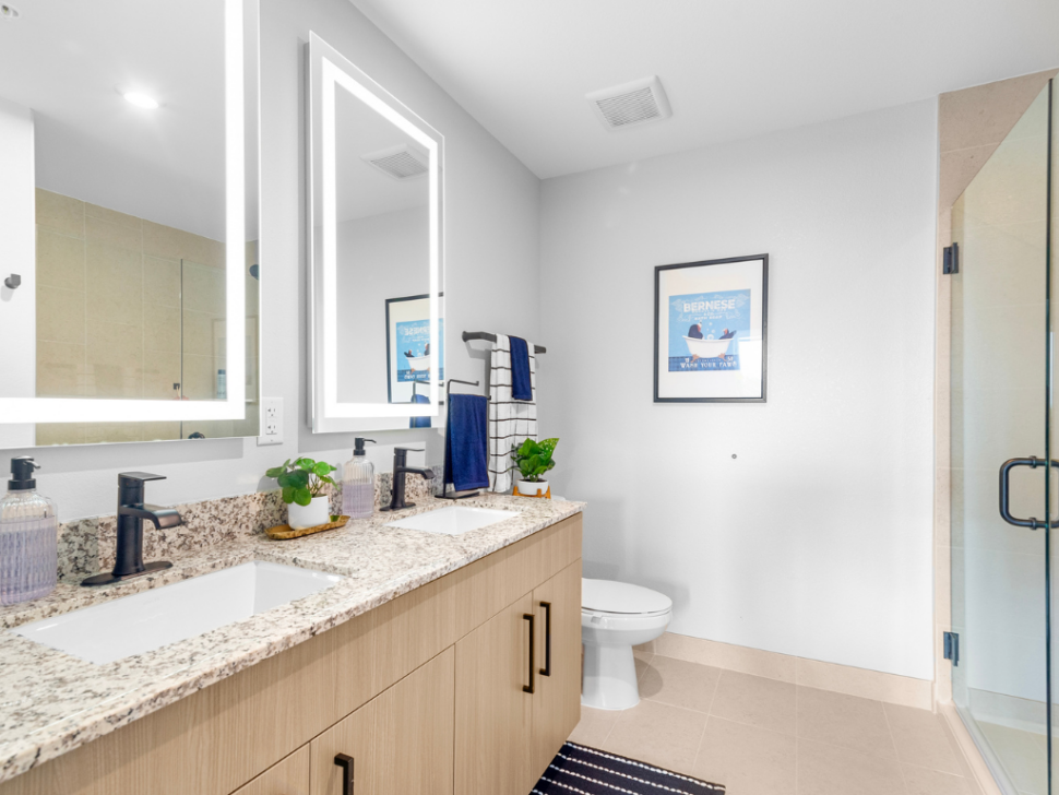 Elegant Bathrooms with LED Mirrors at The Marc Luxury Apartments in Palm Beach Gardens FL